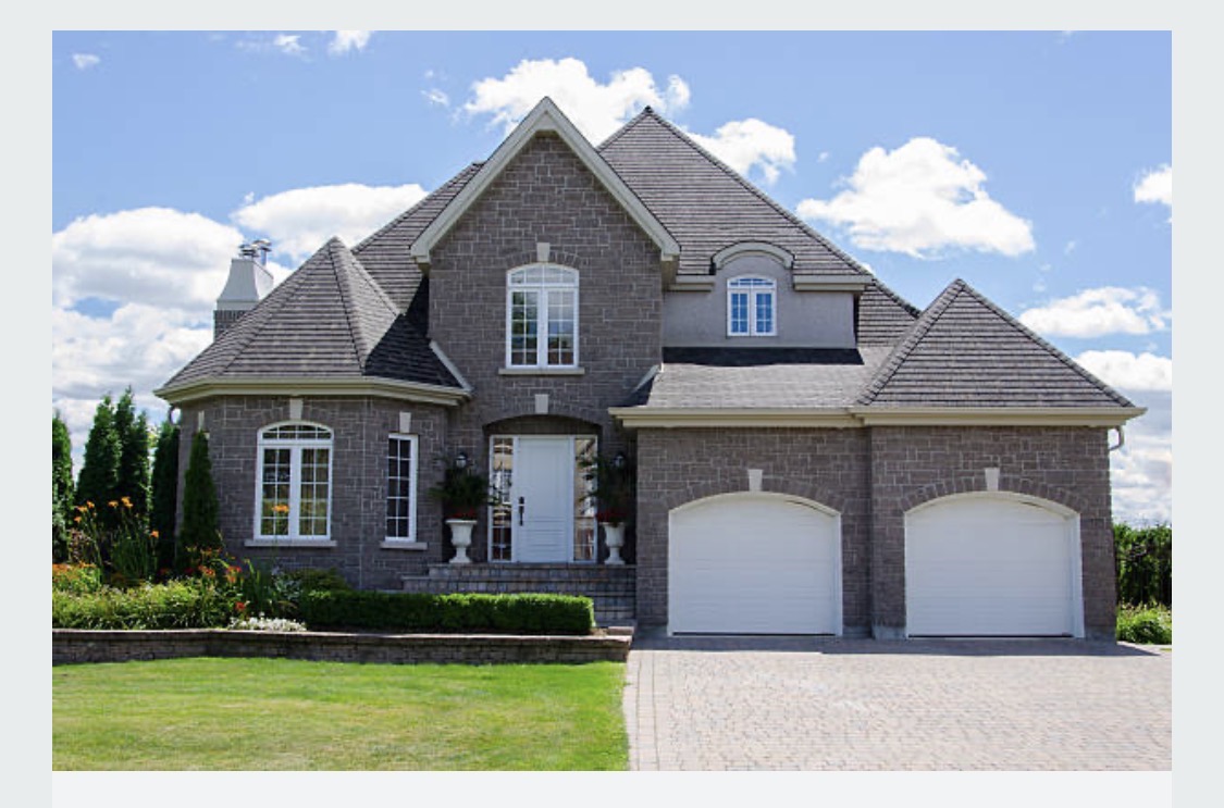 Brick custom home exterior inspiration with gabled rooflines and attached garage
